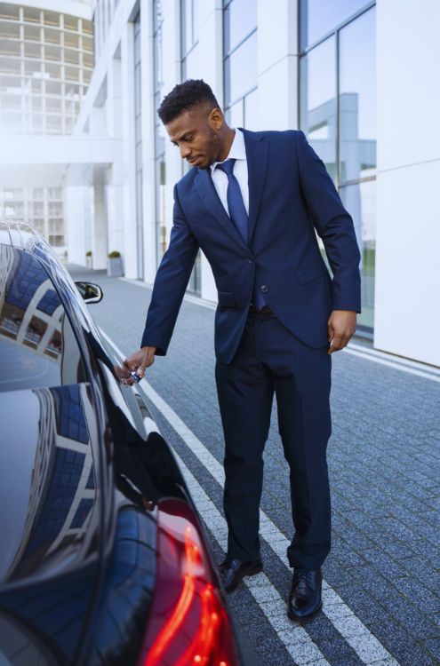 chauffeur standing with car 1